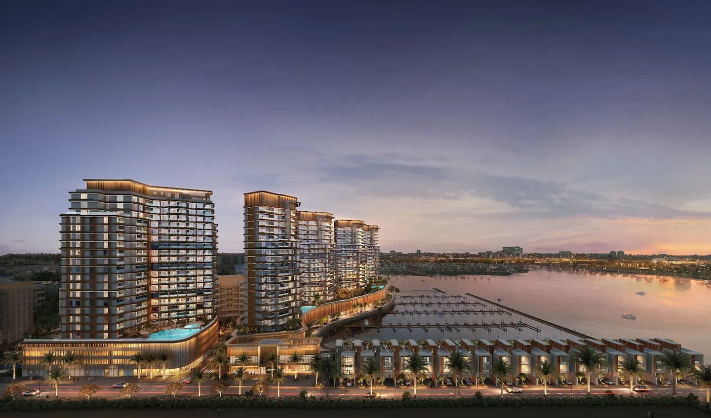 Al Hamra Waterfront: Waterfront towers and marina at dusk — developer rendering